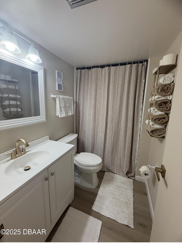 1415 Ocean Shore Blvd Unit 907, Ormond Beach, FL 32176 - bathroom featuring toilet, visible vents, wood finished floors, and vanity