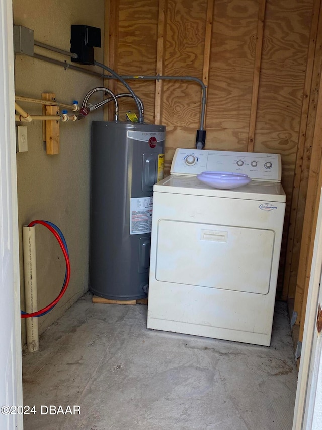 clothes washing area with washer / clothes dryer and water heater