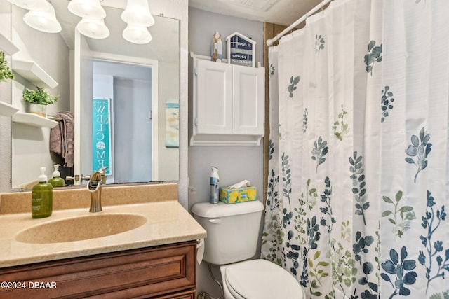 bathroom featuring toilet and vanity