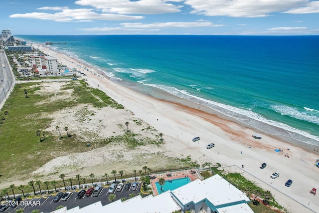 drone / aerial view featuring a beach view and a water view