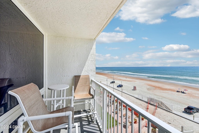 balcony with a beach view and a water view