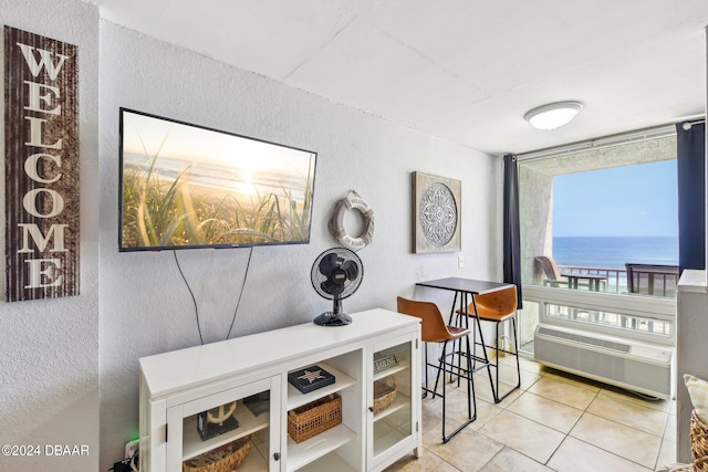 interior space featuring light tile patterned floors and a wall mounted air conditioner