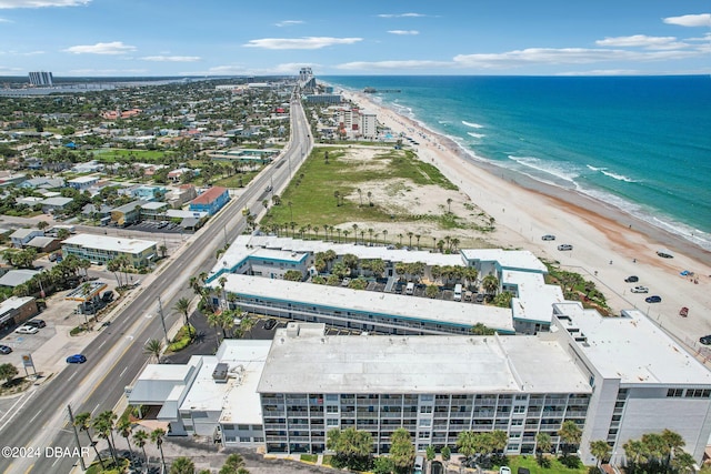 birds eye view of property featuring a beach view and a water view