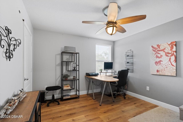 home office featuring hardwood / wood-style flooring and ceiling fan