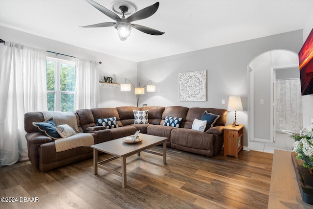 living room with dark hardwood / wood-style flooring and ceiling fan