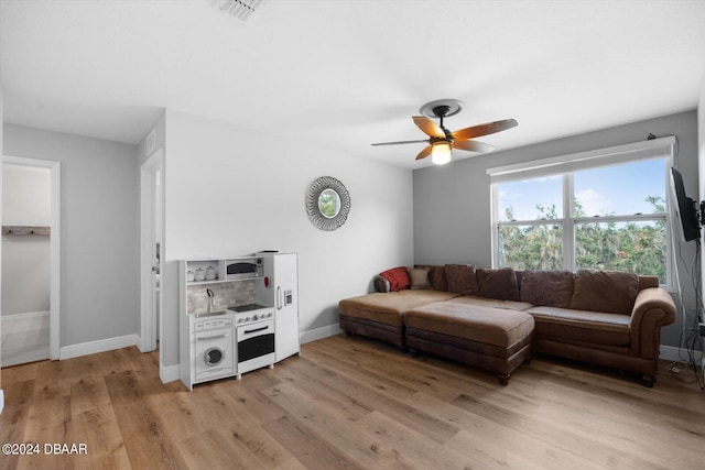 living room featuring ceiling fan and light wood-type flooring