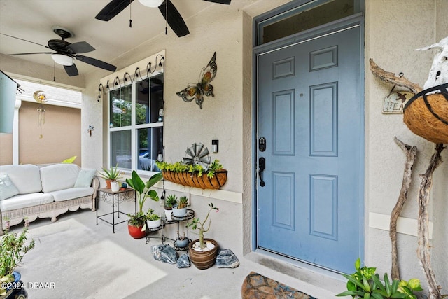 entrance to property with ceiling fan