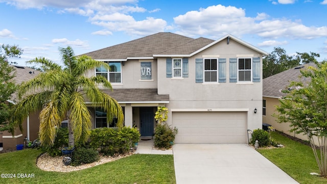 view of front of home with a garage and a front lawn