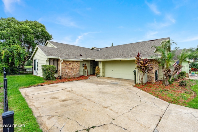 ranch-style home with a front lawn and a garage