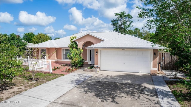 2466 Candlewick St, Deltona, FL 32738 - ranch-style home featuring an attached garage, driveway, stucco siding, and fence