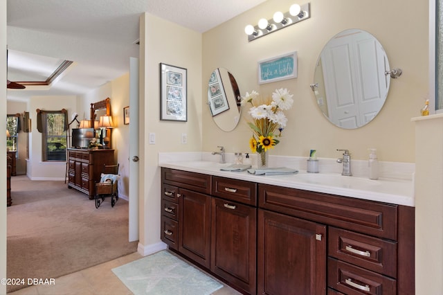 bathroom with tile patterned flooring, vanity, ceiling fan, and a textured ceiling