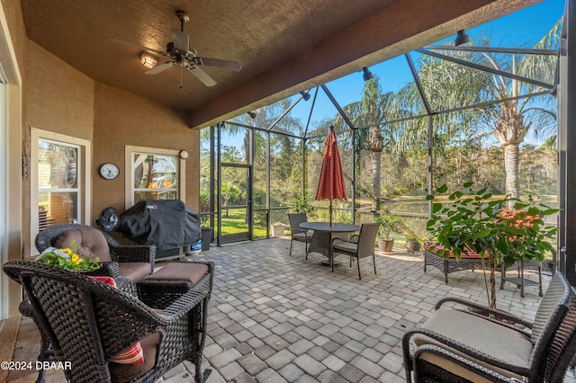 sunroom / solarium featuring ceiling fan and lofted ceiling