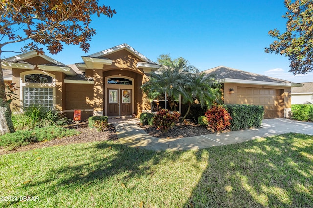 view of front of property featuring a garage and a front yard