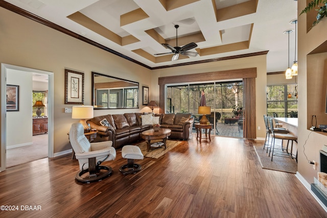 living room featuring hardwood / wood-style flooring, crown molding, ceiling fan, and coffered ceiling