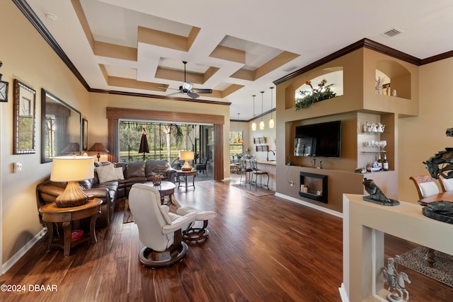 living room featuring ceiling fan, crown molding, dark wood-type flooring, and coffered ceiling