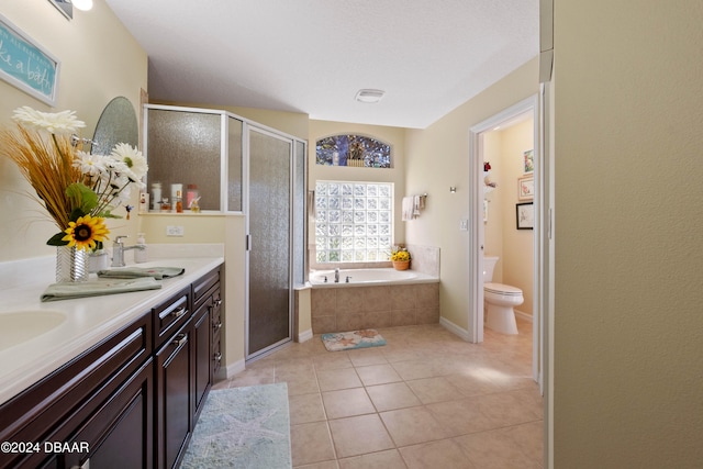 full bathroom with tile patterned floors, plus walk in shower, vanity, and toilet