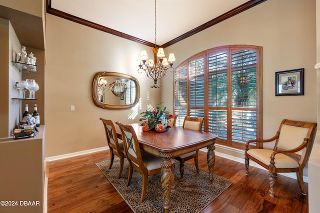 dining space with crown molding, wood-type flooring, and an inviting chandelier