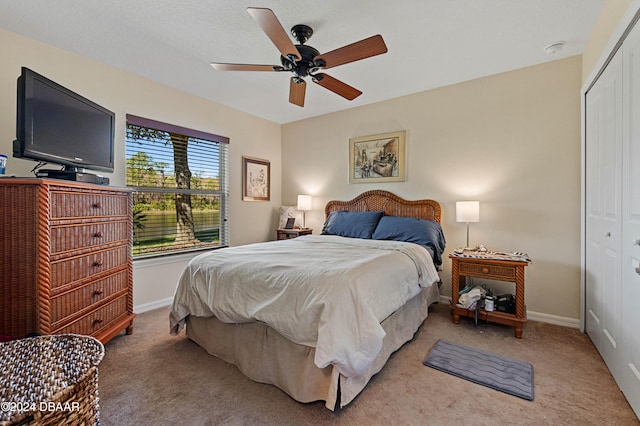 carpeted bedroom with a closet and ceiling fan