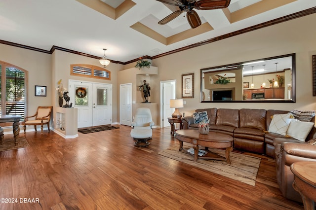 living room with wood-type flooring, crown molding, ceiling fan, and coffered ceiling