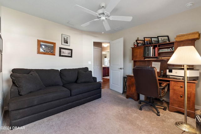 carpeted home office featuring ceiling fan