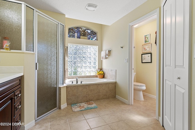 full bathroom with plus walk in shower, vanity, a textured ceiling, and toilet