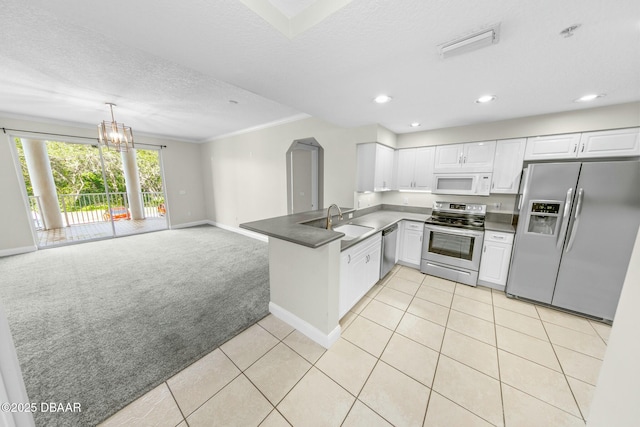 kitchen featuring appliances with stainless steel finishes, sink, white cabinets, kitchen peninsula, and light carpet