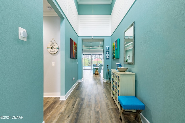 hallway with crown molding and wood-type flooring