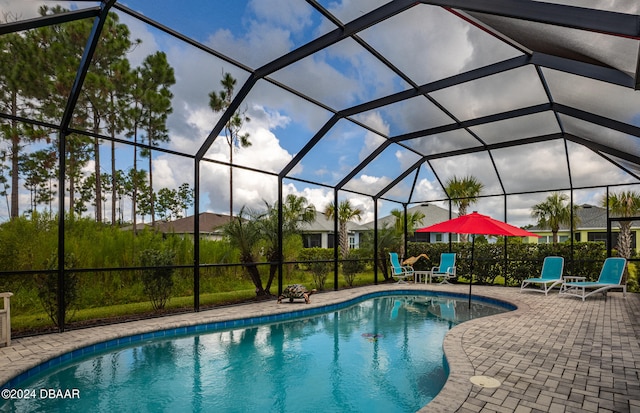 view of pool featuring a patio area and glass enclosure