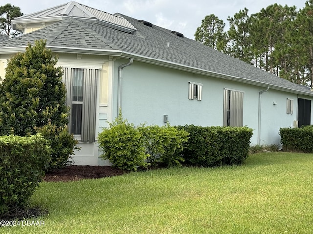 rear view of property with a lawn