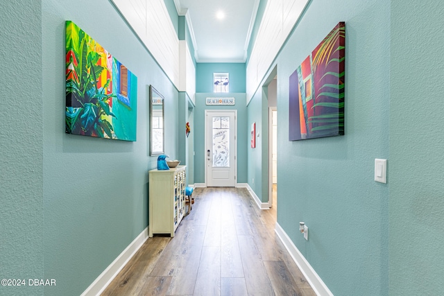 doorway to outside featuring ornamental molding and wood-type flooring