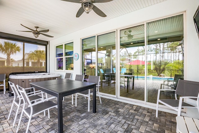 sunroom featuring ceiling fan