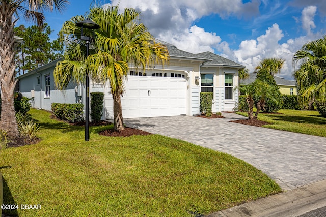 view of front of property featuring a garage and a front yard