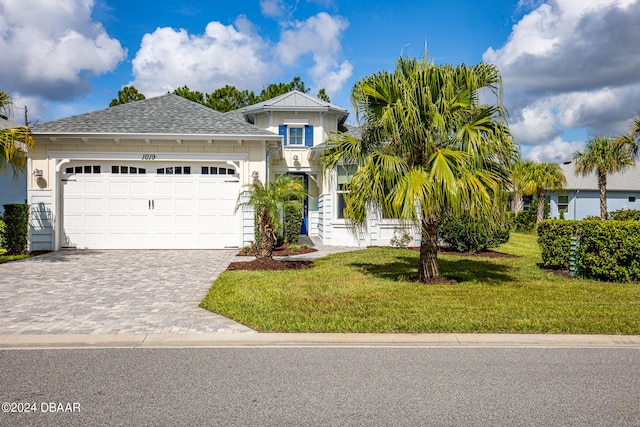 view of front facade featuring a garage and a front lawn