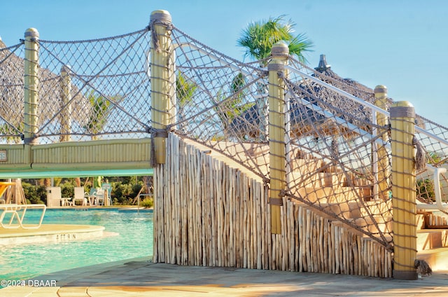 view of gate featuring a community pool