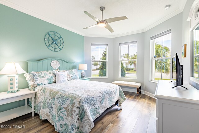 bedroom featuring dark wood-type flooring, ceiling fan, and ornamental molding