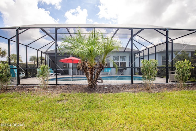 view of pool featuring a yard, glass enclosure, and a patio area