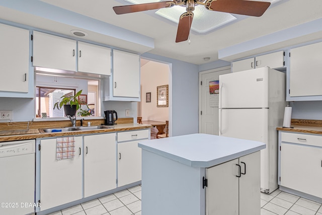 129 Sand Fiddler Ct, Daytona Beach, FL 32119 - kitchen with white appliances, a sink, light tile patterned flooring, and a ceiling fan