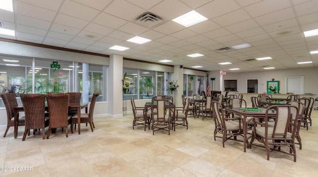 dining space featuring a drop ceiling