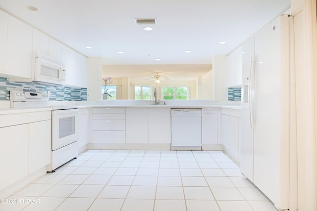 kitchen featuring tasteful backsplash, white cabinetry, white appliances, and sink