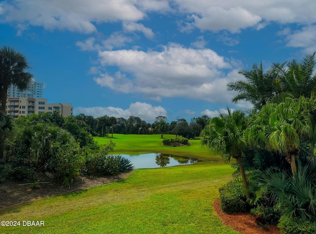 view of home's community featuring a lawn and a water view