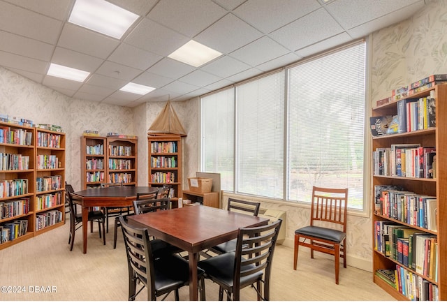 dining space with a drop ceiling