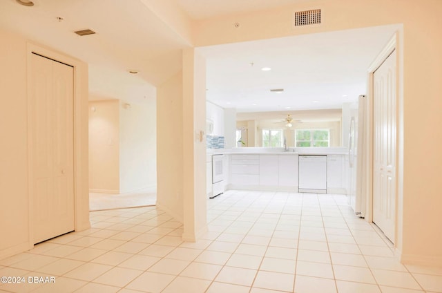 hall featuring light tile patterned floors