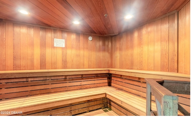 view of sauna / steam room featuring wooden walls and wood ceiling