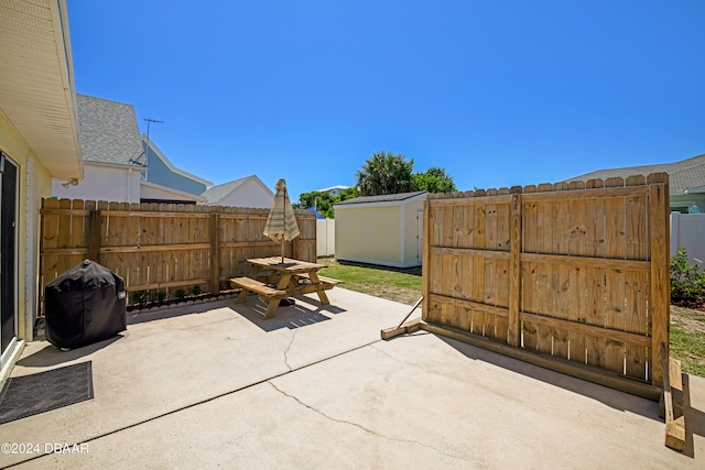 view of patio / terrace with a grill and a shed