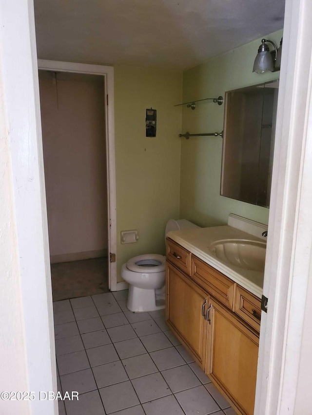 bathroom with tile patterned floors, vanity, and toilet