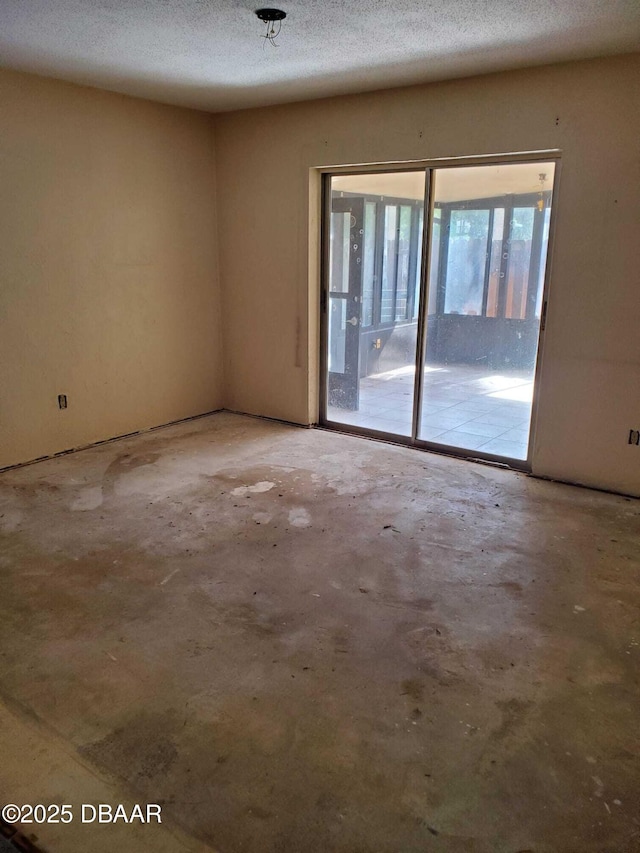 empty room featuring concrete flooring and a textured ceiling