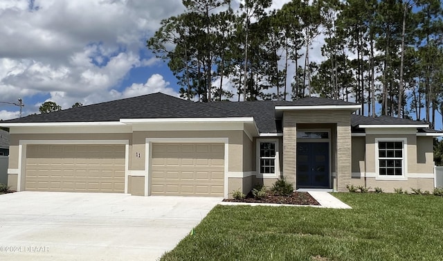 view of front of home with a garage and a front yard