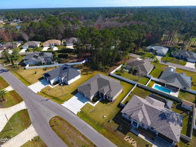 birds eye view of property featuring a forest view and a residential view