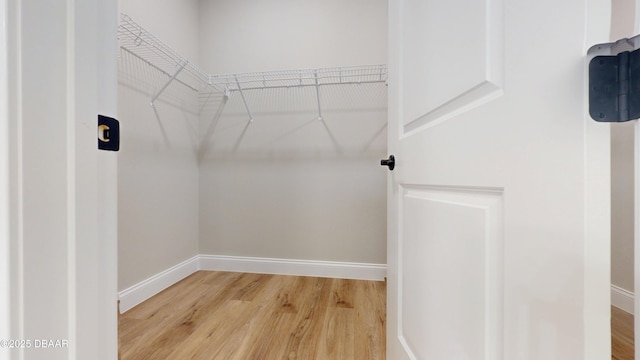 spacious closet with wood finished floors