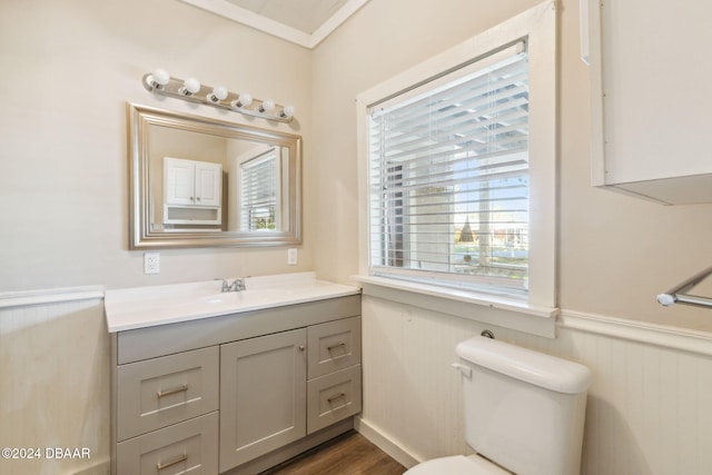 bathroom with vanity, hardwood / wood-style flooring, toilet, and crown molding